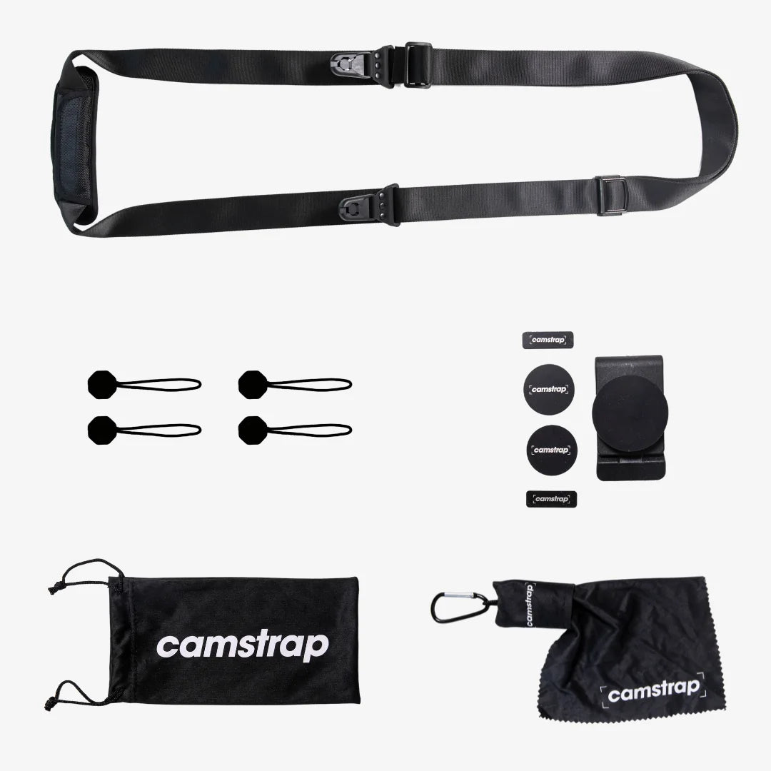 Camstrap Explorer hands-free camera harness worn over both shoulders, supporting a DSLR with a telephoto lens.