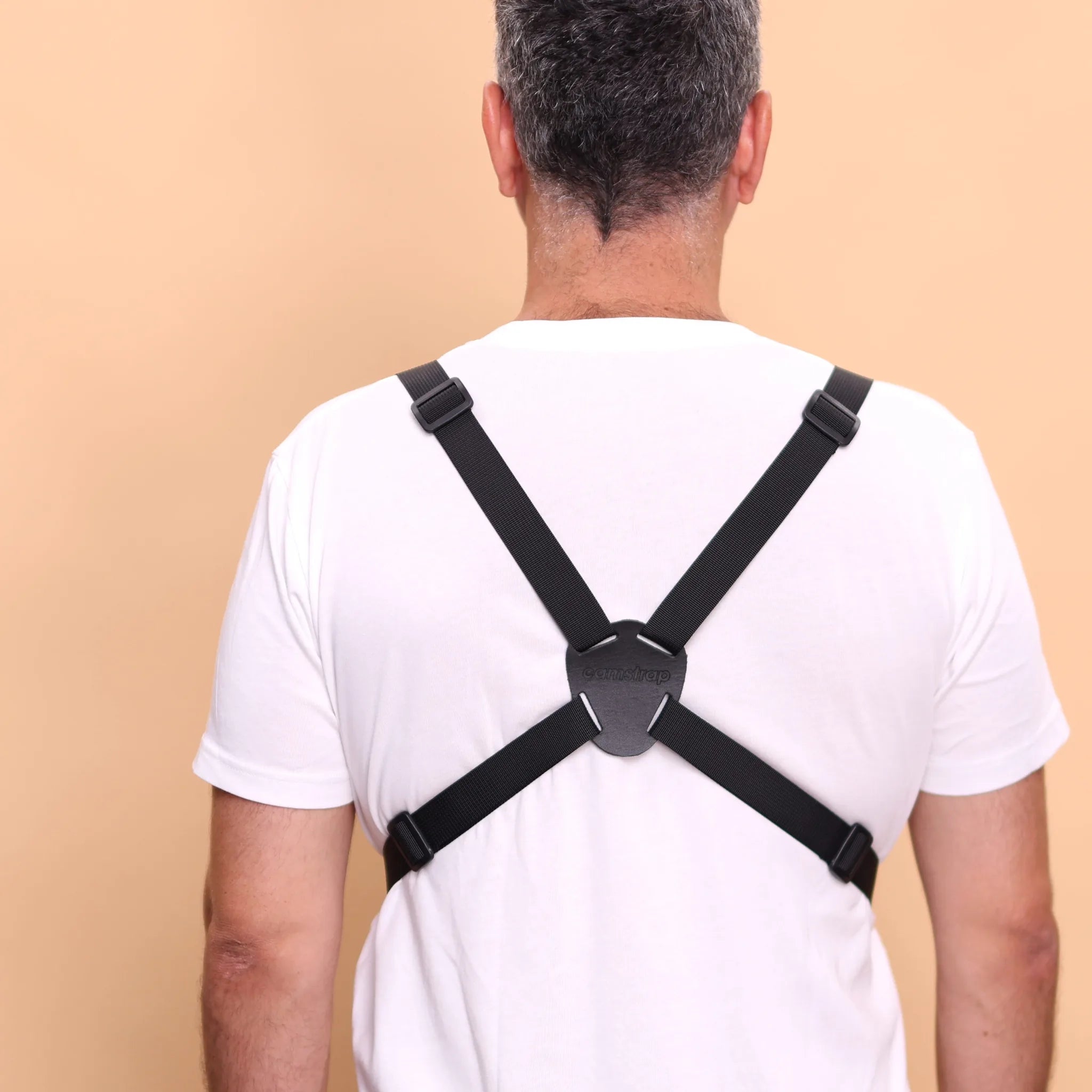 Camstrap Trek harness worn from behind, showing the four adjustment buckles on the shoulder and lower straps