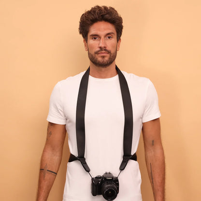 Camstrap Explorer hands-free camera harness worn over both shoulders, supporting a DSLR with a telephoto lens.