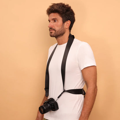 Camstrap Explorer hands-free camera harness worn over both shoulders, supporting a DSLR with a telephoto lens.