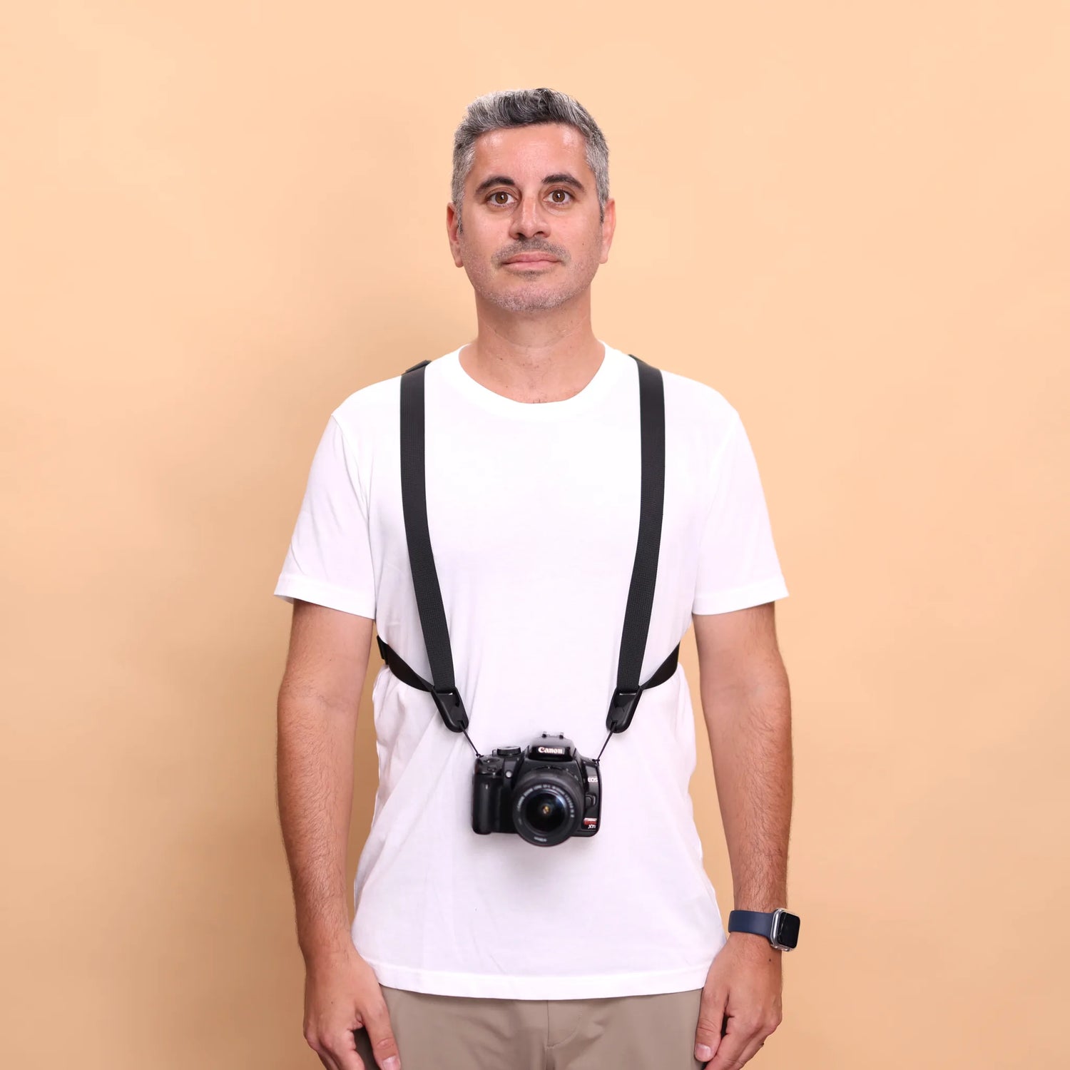Camstrap Trek harness worn over both shoulders, camera hanging at waist height in front