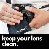 Camstrap microfiber lens cleaning cloth wiping the front element of a DSLR camera lens.