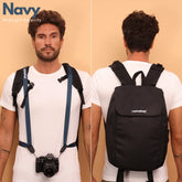 Camstrap Nomad 20L hands-free photography backpack worn on one shoulder with a DSLR clipped to the strap.