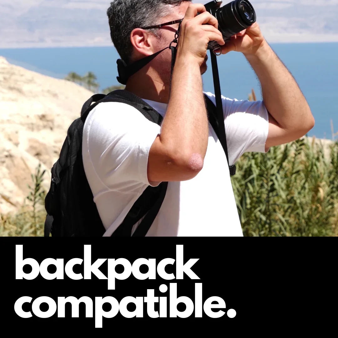 Camstrap Explorer hands-free camera harness worn over both shoulders, supporting a DSLR with a telephoto lens.