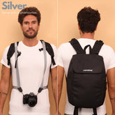 Camstrap Nomad 20L hands-free photography backpack worn on one shoulder with a DSLR clipped to the strap.