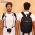 Camstrap Nomad 20L hands-free photography backpack worn on one shoulder with a DSLR clipped to the strap.