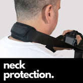 Camstrap Explorer hands-free camera harness worn over both shoulders, supporting a DSLR with a telephoto lens.