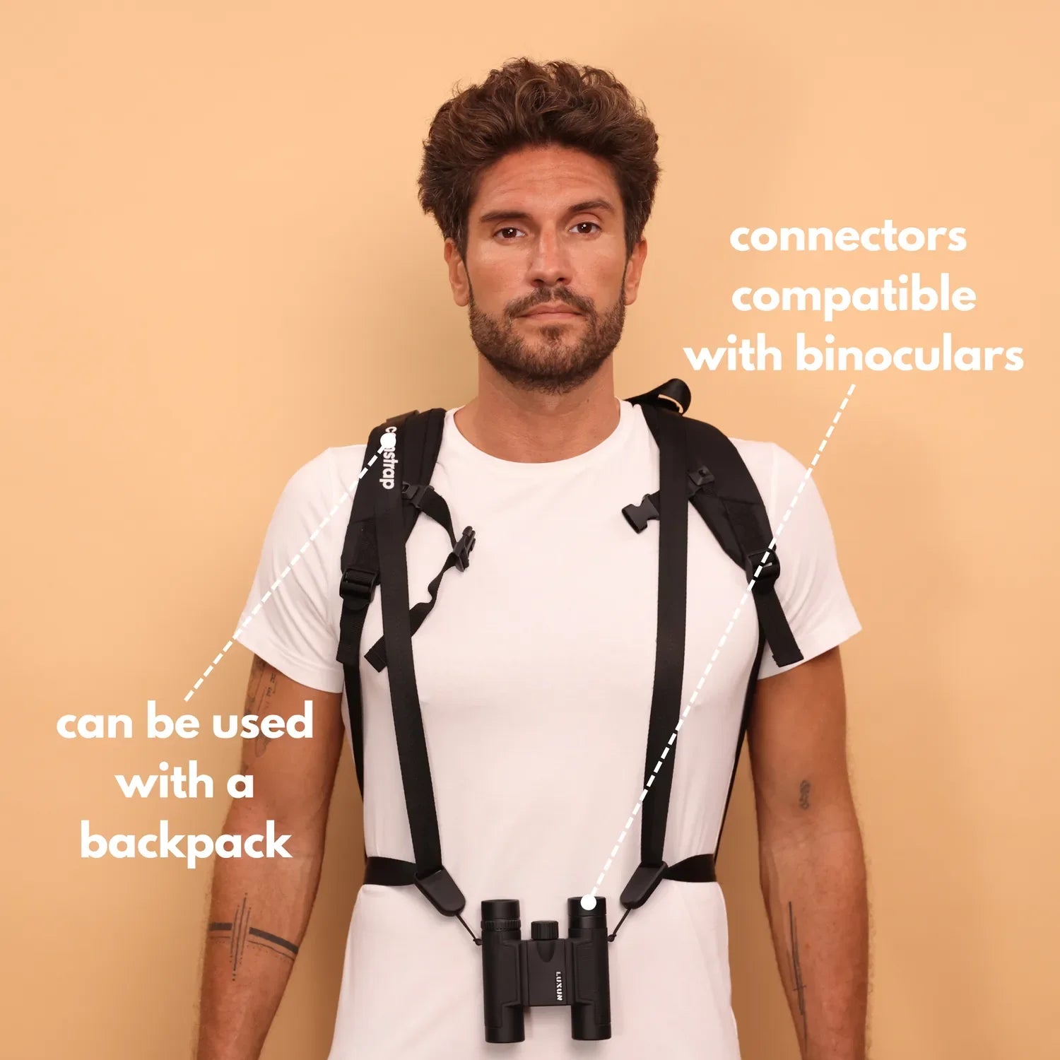 Camstrap Voyager hands-free camera strap worn across the torso, holding a DSLR close to the body.