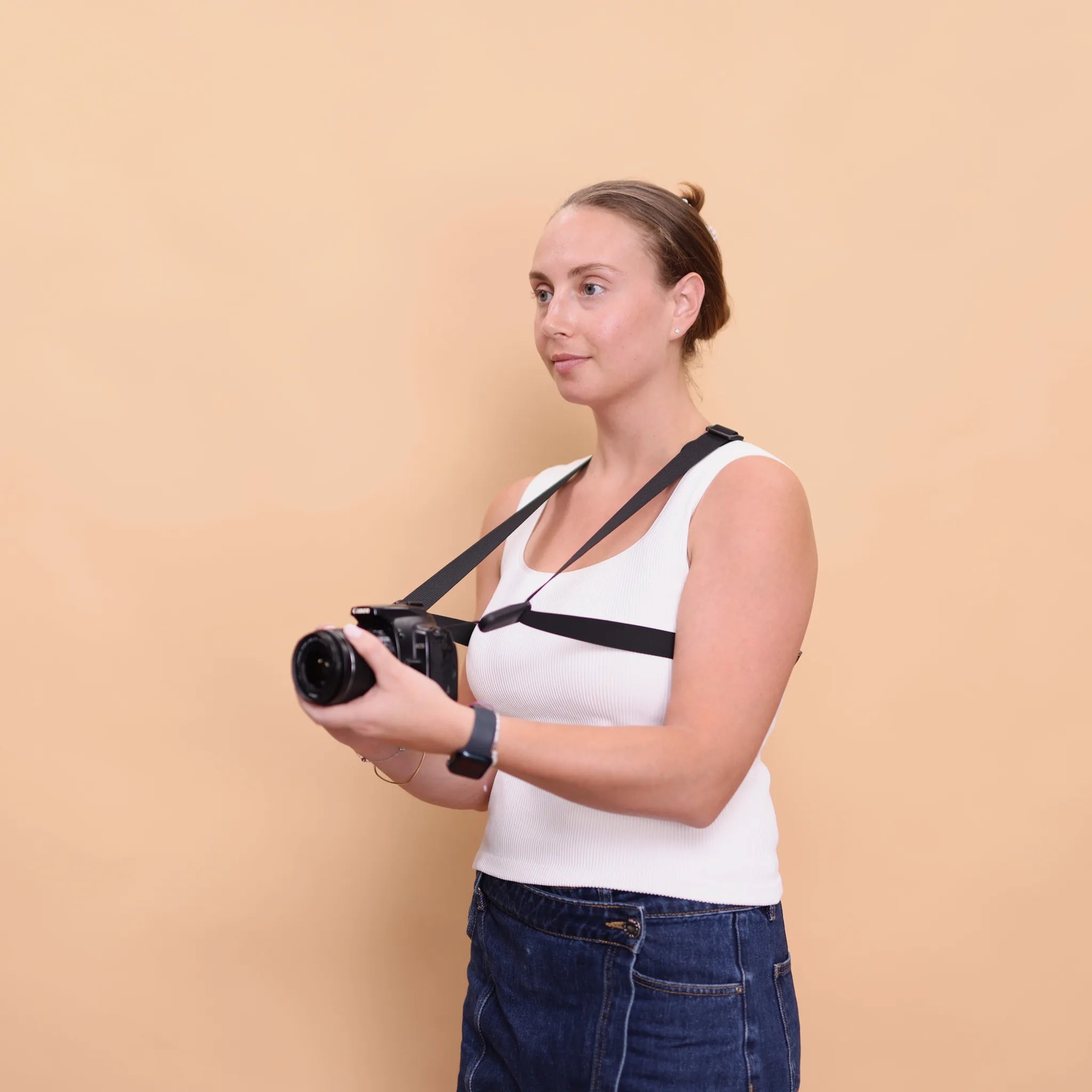 Camstrap Trek worn in side profile, camera held clear of the body