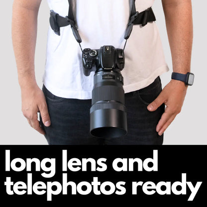 Camstrap Explorer hands-free camera harness worn over both shoulders, supporting a DSLR with a telephoto lens.