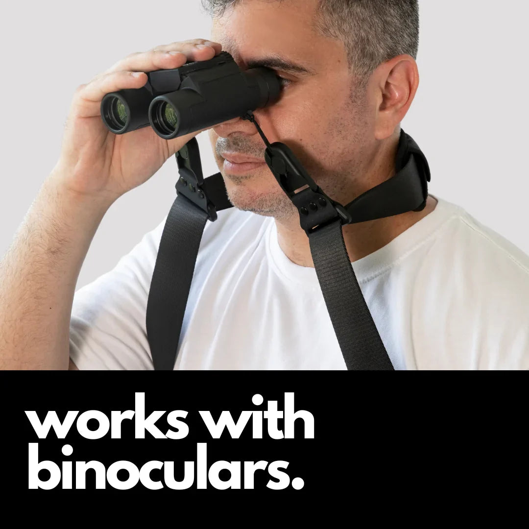 Camstrap Explorer hands-free camera harness worn over both shoulders, supporting a DSLR with a telephoto lens.
