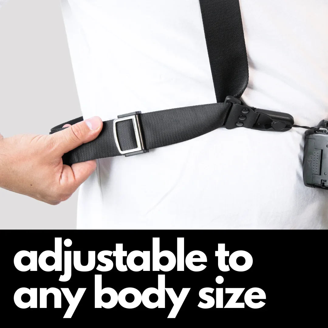 Camstrap Explorer hands-free camera harness worn over both shoulders, supporting a DSLR with a telephoto lens.