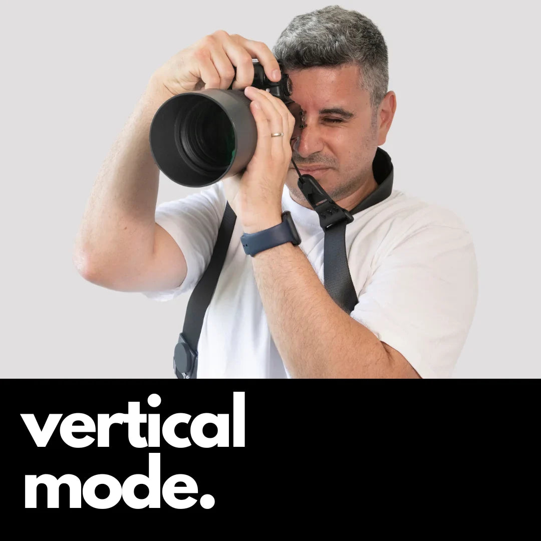 Camstrap Explorer hands-free camera harness worn over both shoulders, supporting a DSLR with a telephoto lens.