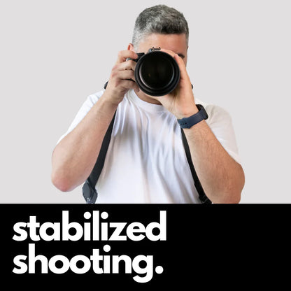 Camstrap Explorer hands-free camera harness worn over both shoulders, supporting a DSLR with a telephoto lens.