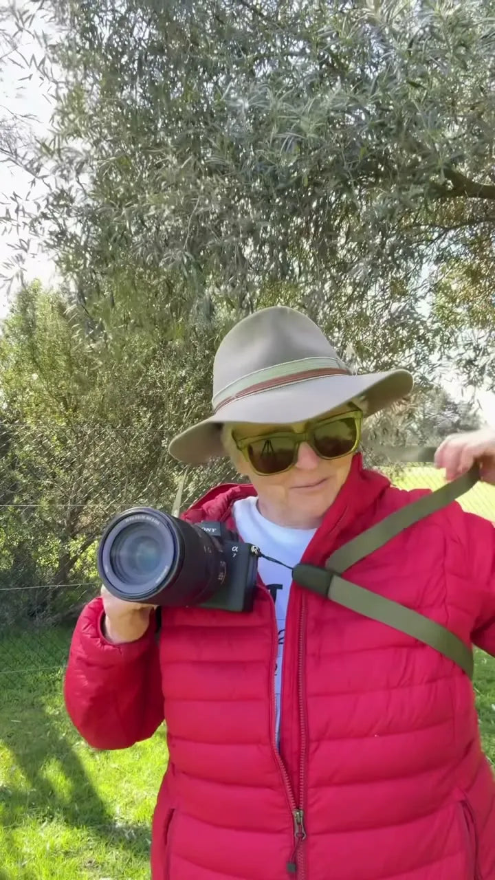 Derry Caulfield raising a camera, wearing a Camstrap harness