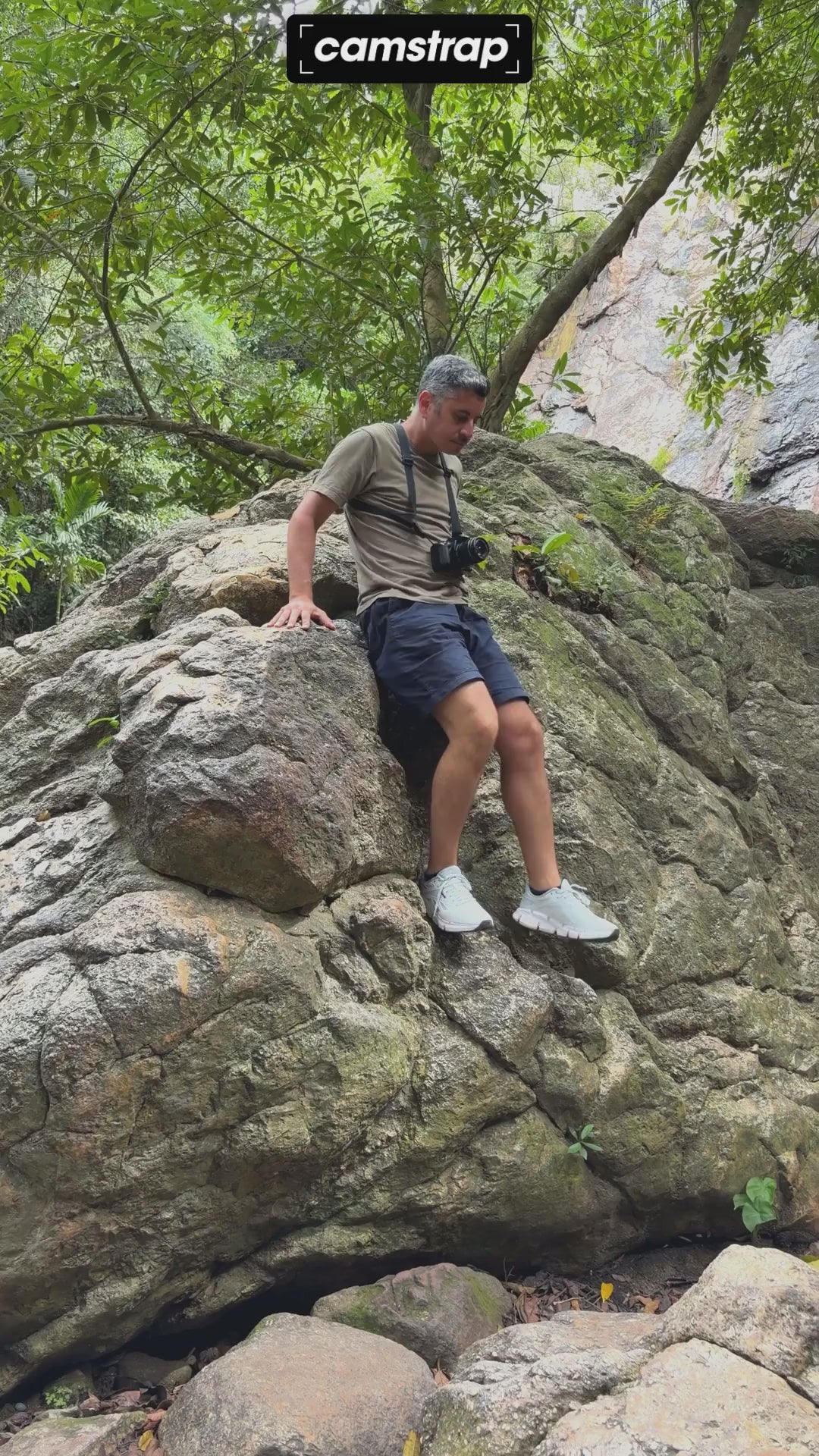Camstrap Trek harness worn on both shoulders while walking and climbing outdoors, with a camera carried at the chest